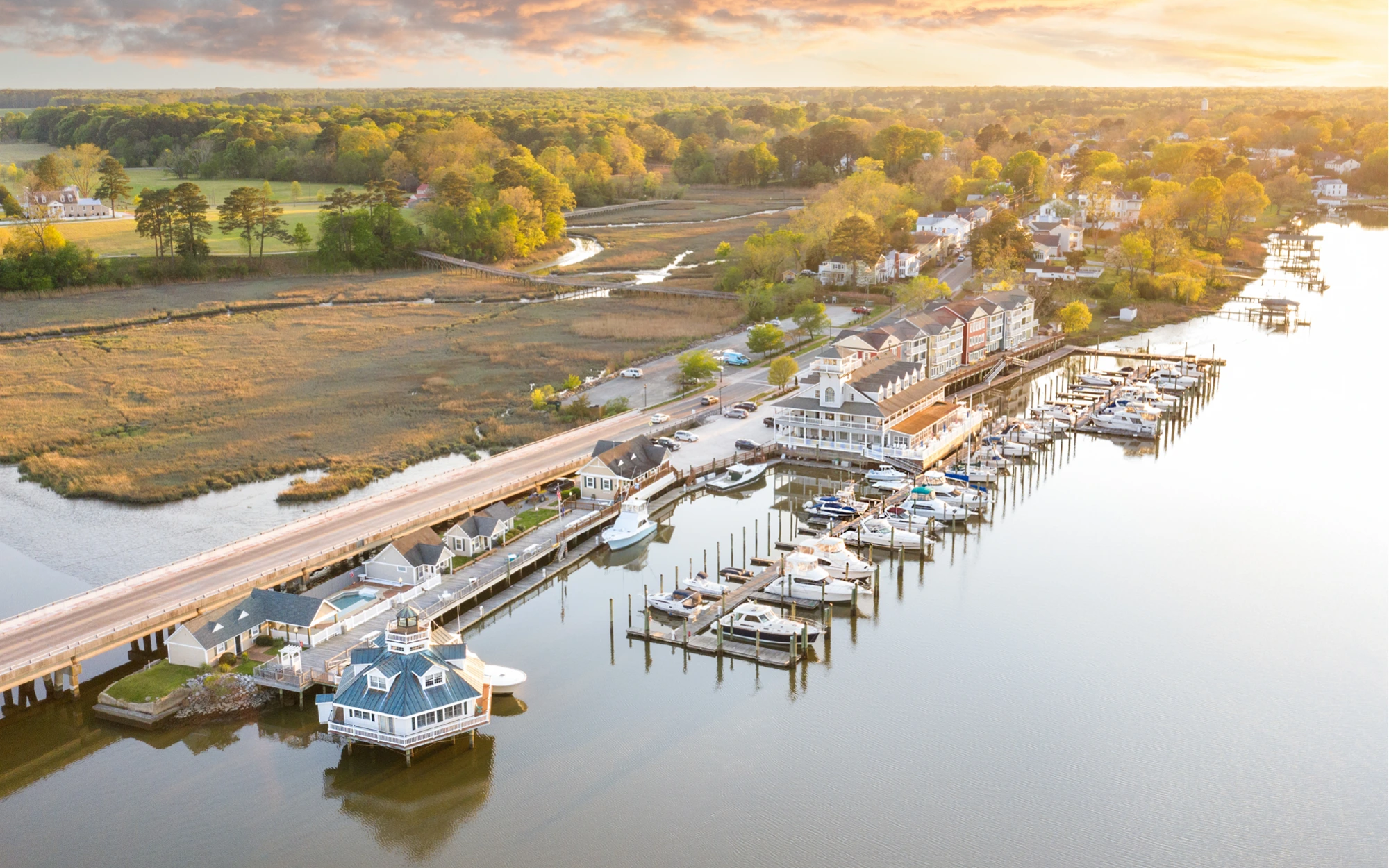 Aerial view of a Pack Brothers waterfront marina at sunset